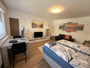 a bedroom with a bed and a living room at Haus Kormoran Borkum in Borkum