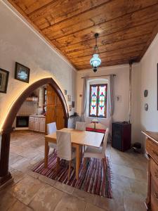 a dining room with a wooden table and chairs at Byzantino Omodos House in Omodos
