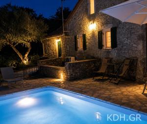 a villa with a swimming pool at night at Private Villa Demetra 1768 with pool - close to Fiskardo in Fiskardo