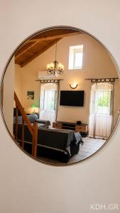 a mirror reflecting a room with a bed and a tv at Private Villa Demetra 1768 with pool - close to Fiskardo in Fiskardo