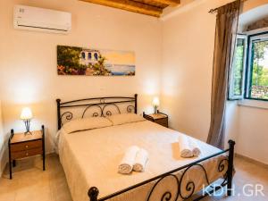 a bedroom with a bed with two towels on it at Private Villa Demetra 1768 with pool - close to Fiskardo in Fiskardo