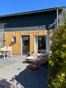 a patio with a bench in front of a house at Stodoła in Postomino