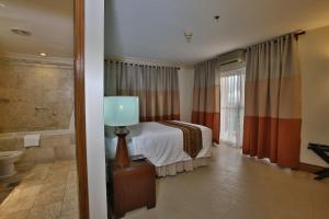 Ένα ή περισσότερα κρεβάτια σε δωμάτιο στο Crown Regency Suites Mactan