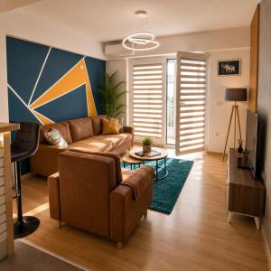 a living room with a couch and a tv at Apartment Moki in Skopje
