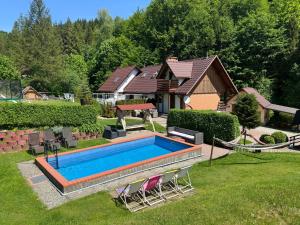 a swimming pool in the yard of a house at Apartamenty Kadłubek in Wisła