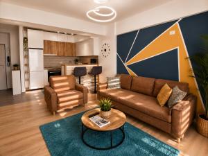 a living room with a couch and a table and a kitchen at Apartment Moki in Skopje
