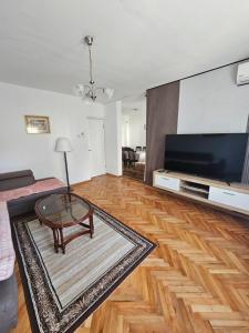 a living room with a coffee table and a flat screen tv at Apartment Jasovic in Ulcinj
