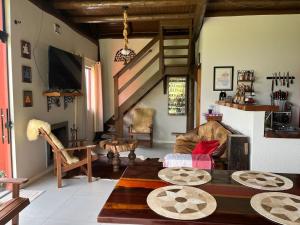 a living room with a couch and a table at Chalé Manacá da Serra in São Bento do Sul
