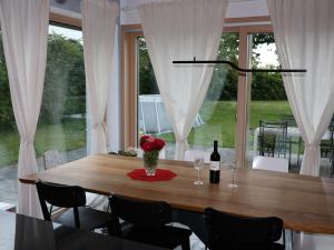 a dining room with a table with a bottle of wine at Hiša Kovač in Velesovo