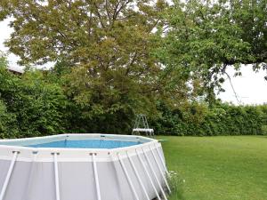 a swimming pool in a yard with a tree at Hiša Kovač in Velesovo
