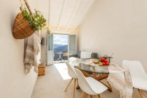 a kitchen and dining room with a table and chairs at Marinaio di foresta Bedroom in Baunei