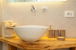 a bathroom with a white bowl on a wooden table at Marinaio di foresta Bedroom in Baunei +48 photos