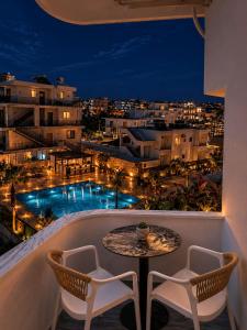 a balcony with a table and chairs and a view of a city at Sea Hotel in Ksamil