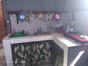 a kitchen with a sink and some pots and pans at TAMATAVE Chez Bien Aimée in Toamasina