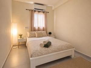 a bedroom with a bed with two towels on it at Coastal Comfort in Haifa