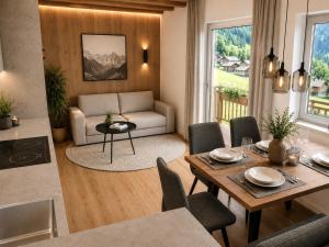a living room with a table and a couch at Villa Erika - NEW Luxury Alpine Apartments from December 2026 in Sesto