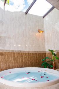 a bath tub filled with confetti in a bathroom at Pousada Medeiros in Monte Verde