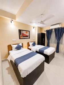 a hotel room with two beds in a room at The Happy Nest- A Boutique Stay only 7 mins from Nemcare, Apollo, Physicswalla, Allen in Guwahati +40 photos