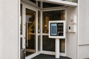 a pay phone in front of a door at Hotel am Hirschgarten in Filderstadt