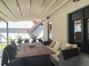 a table and chairs and a couch on a patio at Petite Mansion in Našice