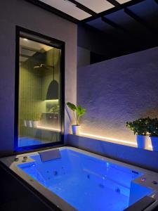 a jacuzzi tub in a room with a window at Artis Blue Relax in Himare