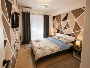 a bedroom with a bed and a tv in it at Apartment Moki in Skopje