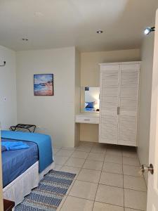 a bedroom with a bed and a desk in it at Riseland Breeze Collection in Carnbee Village