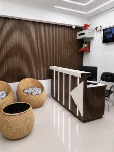 a lobby with chairs and a table with an arrow at The Happy Nest- A Boutique Stay only 7 mins from Nemcare, Apollo, Physicswalla, Allen in Guwahati
