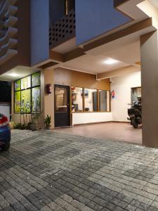 a building with a car parked in a parking lot at The Happy Nest- A Boutique Stay only 7 mins from Nemcare, Apollo, Physicswalla, Allen in Guwahati