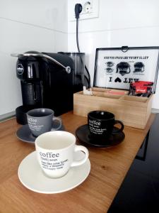 two coffee cups on a table with a coffee maker at SOLU Luxury Apartments with Free Parking ,Fast Wi -Fi, New Building in Skopje