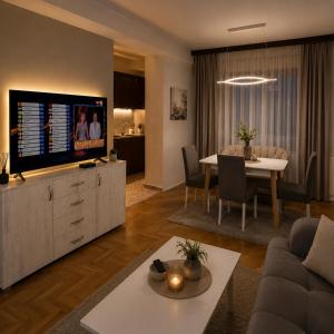 a living room with a couch and a dining room at AS Lux apartment tetovo in Tetovo