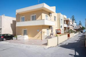 a building on the side of a street at Rosmaris Apartments in Platanias