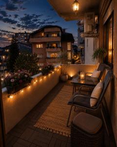 a balcony with lights and a table and chairs at AS Lux apartment tetovo in Tetovo