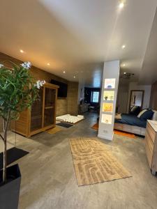 a living room with a couch and a refrigerator at Les Nuits Douces in Bitche