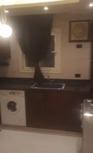 a kitchen with a sink and a stove at جسر السويس نفرتاري in Obour