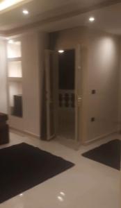 a living room with black mats on the floor at جسر السويس نفرتاري in Obour