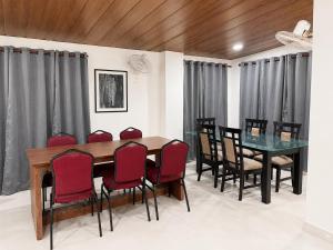a dining room with a table and chairs at The Happy Nest- A Boutique Stay only 7 mins from Nemcare, Apollo, Physicswalla, Allen in Guwahati