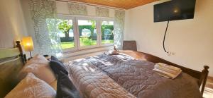 a bedroom with a bed with a cat laying on it at Ferienhaus am Seeblick Grill, Garten, Billiard, Dart, Bike, Sauna ww-Seeblick in Driedorf