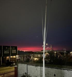 a view of a city at night with a street light at La Casita Austral in Punta Arenas +1 photo