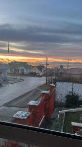 a view from a window of a parking lot with snow at La Casita Austral in Punta Arenas