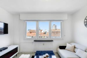 a living room with a couch and a large window at Blāck diamond spa in Mulhouse