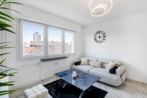 a living room with a couch and a table at Blāck diamond spa in Mulhouse