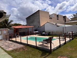 a swimming pool in front of a building at Casa Branca in Saquarema