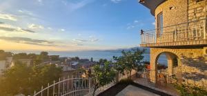 a balcony of a building with a view of the ocean at Hyka Stone House Shkoder in Shkodër
