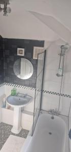 a bathroom with a sink and a mirror at 4 Boteler Avenue,Bewsey in Warrington +3 photos