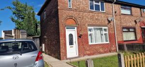 a car parked in front of a brick house at 4 Boteler Avenue,Bewsey in Warrington