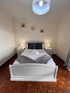 a bedroom with a large white bed with two night stands at Madeira Ocean View in Funchal