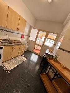 a kitchen with a sink and a table in it at Madeira Ocean View in Funchal
