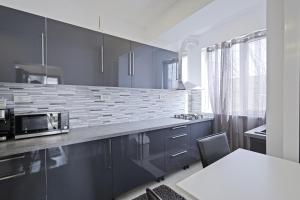 a kitchen with blue cabinets and a counter top at Apartament Kiri in Mangalia