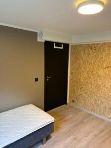 a room with a bed and a black door at Wergelandsvegen 40B in Stjoerdal +12 photos